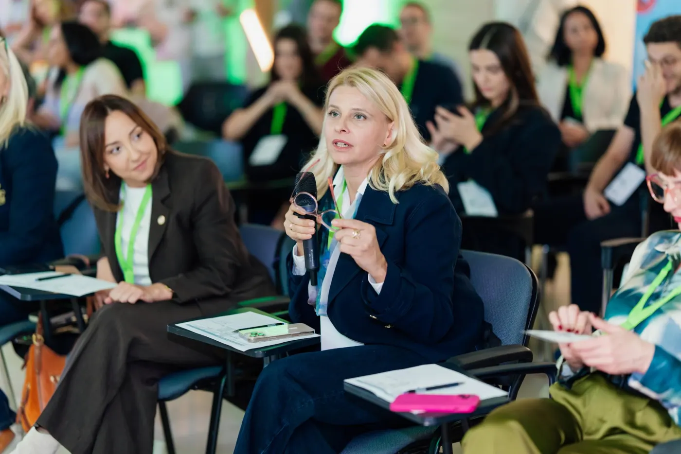 A mentor in the audience asking a question into a microphone during the pitches
