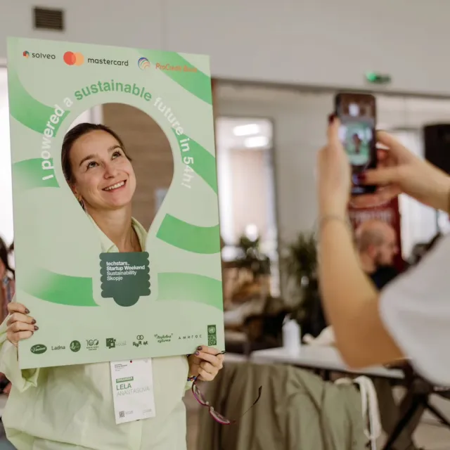 An organiser posing inside the event's light-bulb photo frame