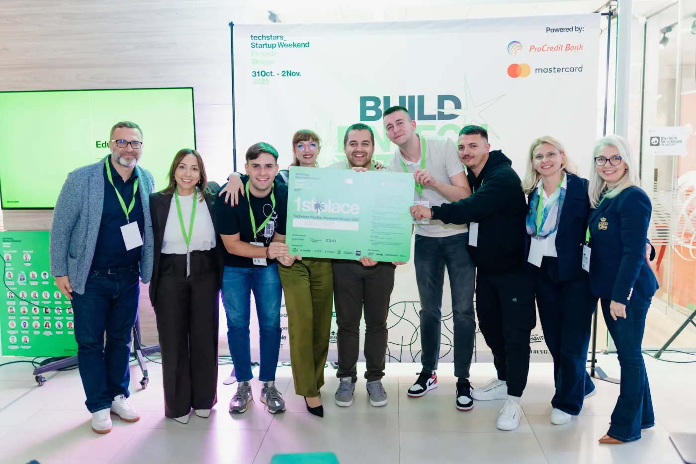 The winning team holding the first place cheque with the judges and organisers